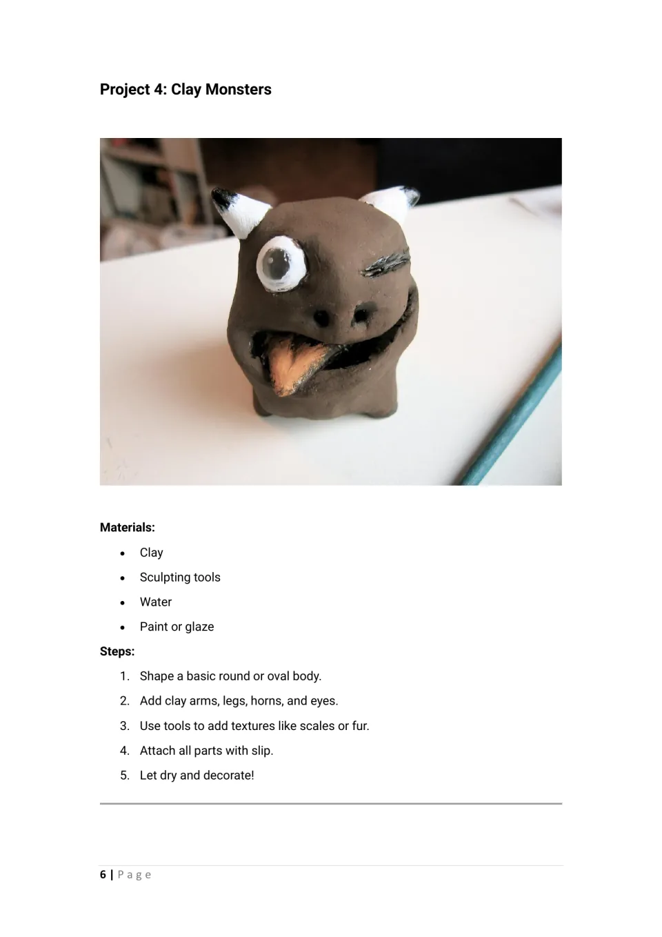 Clay monsters: students shape a round body, attach horns and eyes with slip and carve texture; one-eyed monster photo