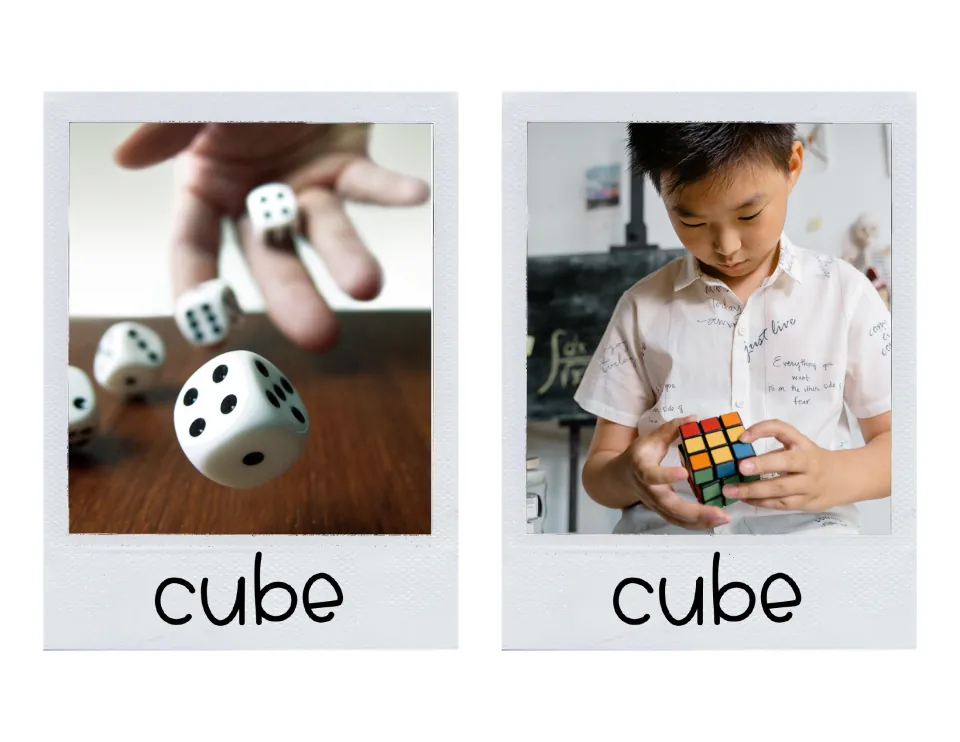 Large cube cards picturing white dice being rolled onto a table and a boy turning a colorful puzzle cube in his hands