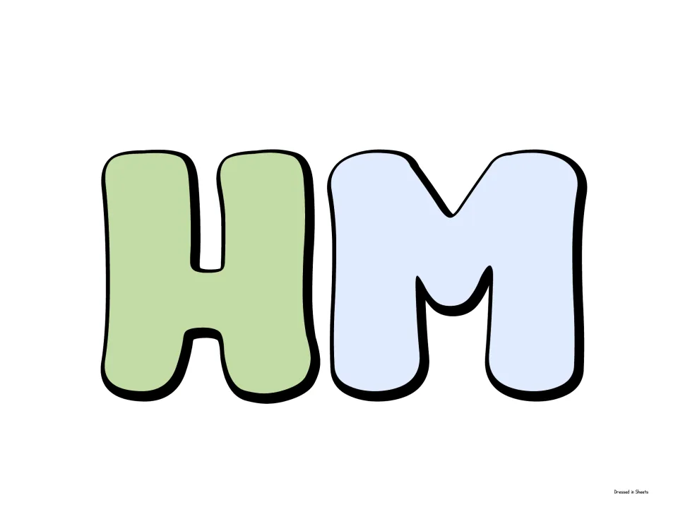 Bubble letters H and M in green and light blue, a cut-out piece of the Accomplishments heading for the cork board