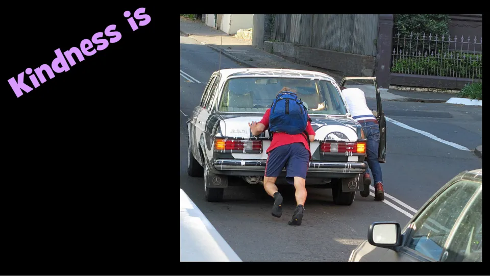 Kindness example slide pairs the heading “Kindness is” with people helping push a car along a street.