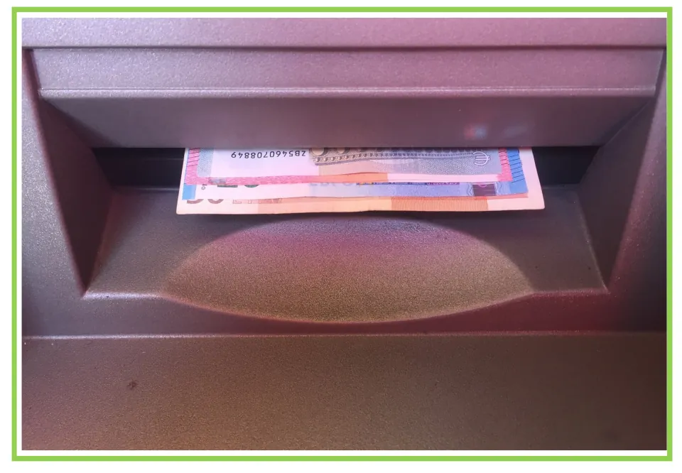 Withdrawal picture card: photo of banknotes coming out of a cash machine slot, unlabeled so students recall the sign