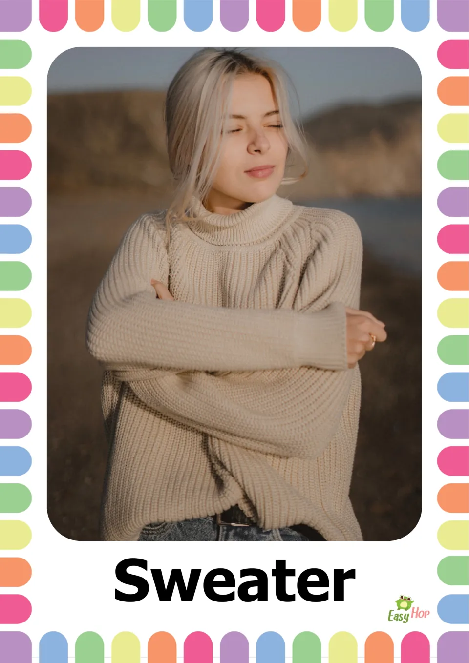 Autumn clothing vocabulary flashcard 2: the word 'Sweater' paired with a person wearing a cream knit sweater