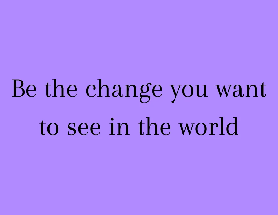 Citizenship quote sign: "Be the change you want to see in the world" in thin black serif type on a lavender background