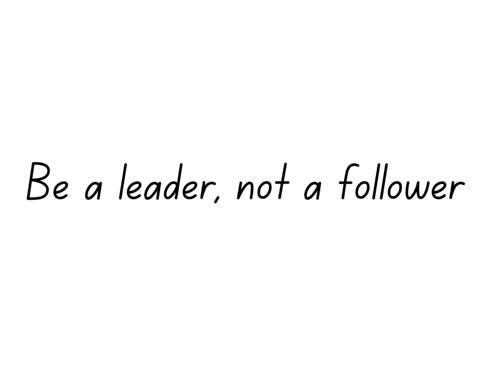 Leadership quote sign reading "Be a leader, not a follower" in thin black handwriting-style print