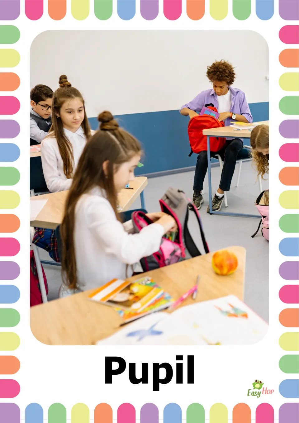 Vocabulary flashcard labeled 'Pupil' showing students at classroom desks unpacking their school bags