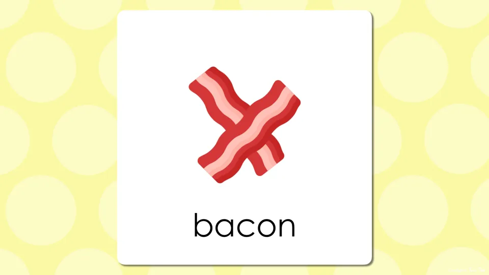 Breakfast vocabulary slide pairing a picture of two crossed bacon strips with the word bacon so students check their guess
