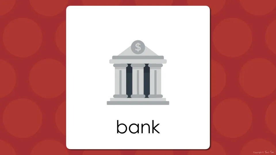 Building vocabulary presentation slide showing the word “bank” beneath a building marked with a dollar sign