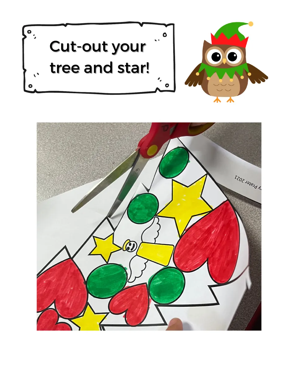 Cut out your tree and star: photo of scissors trimming a colored tree decorated with hearts, stars and circles