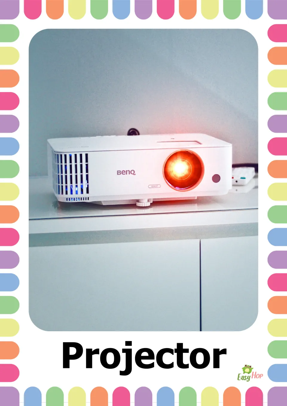 Projector vocabulary photo: a white projector with a glowing orange lens on a cabinet, labeled with the word Projector