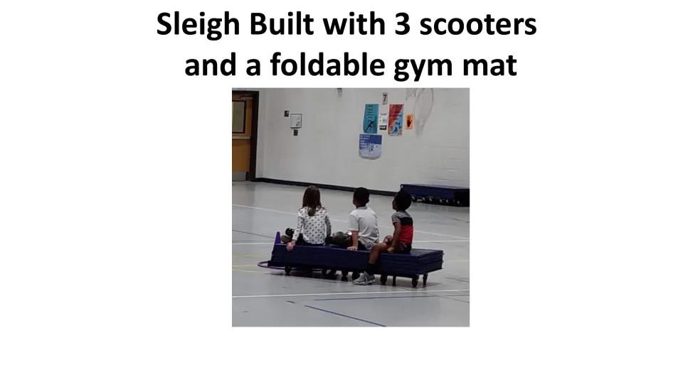 Sleigh construction example for the PE game shows a folded gym mat on three scooters with students seated on top