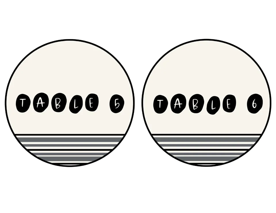 Circle signs reading Table 5 and Table 6, white hand-lettered letters on black pebble shapes over gray farmhouse stripes