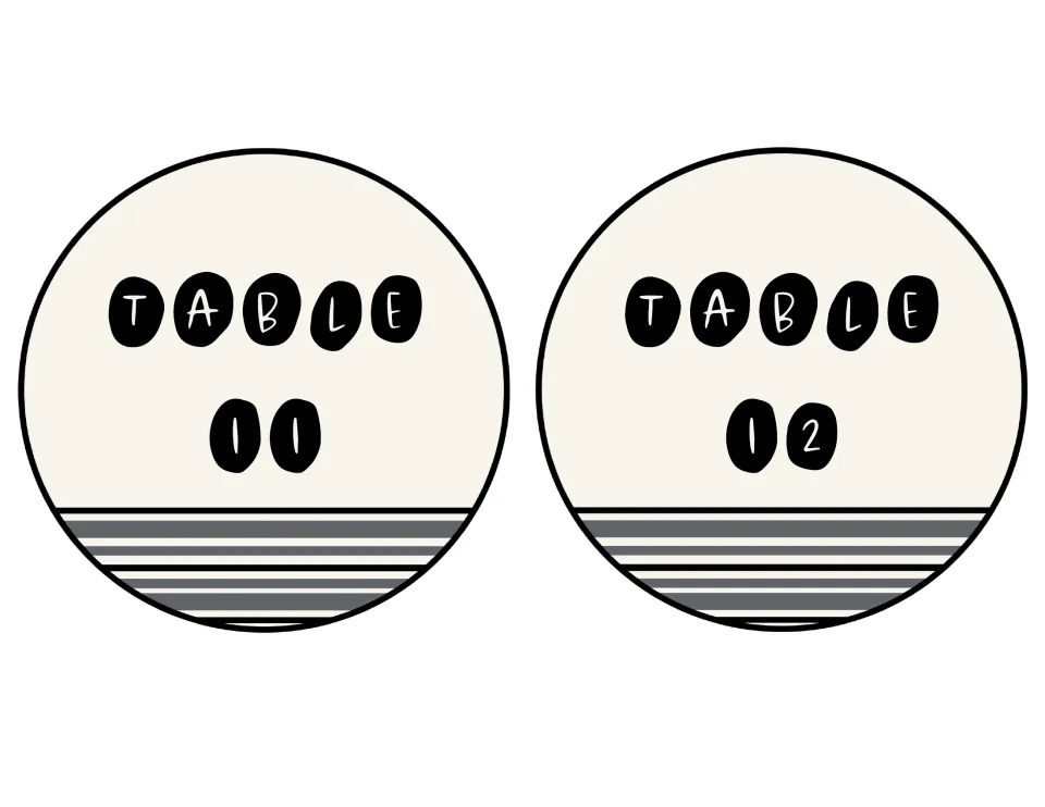 Circle signs for Table 11 and Table 12, each with TABLE on top and the number below in black pebble lettering