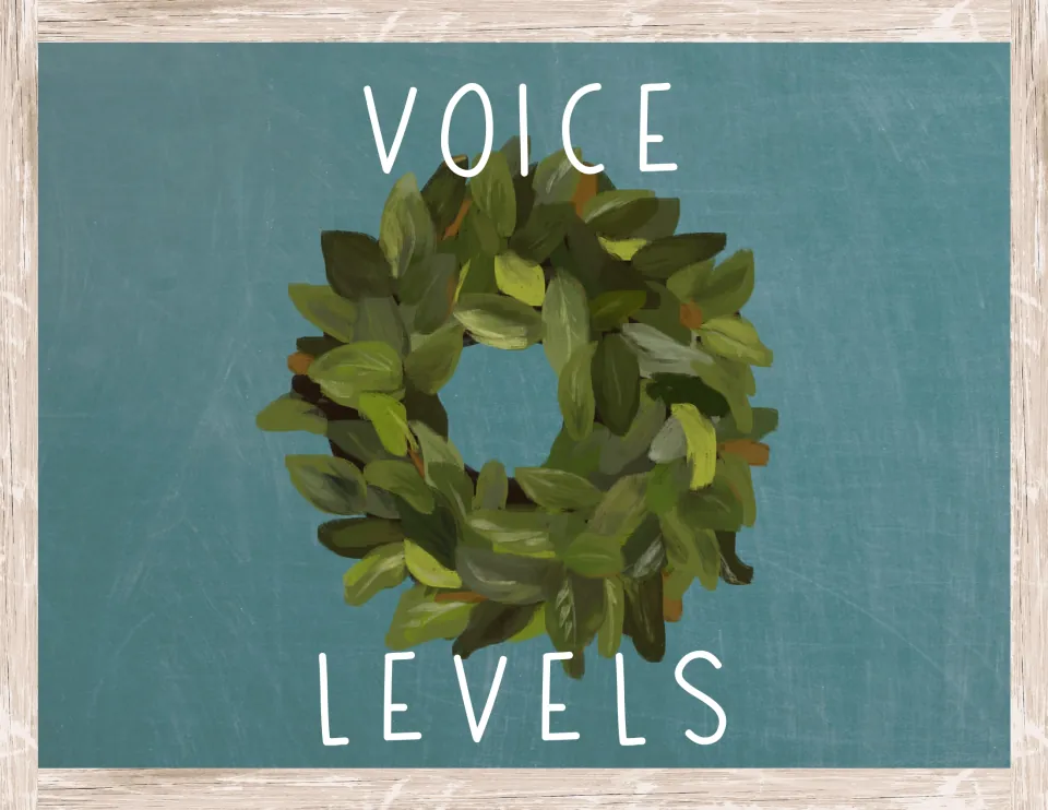 Voice levels title sign with the words in white lettering above and below a painted green leaf wreath on teal