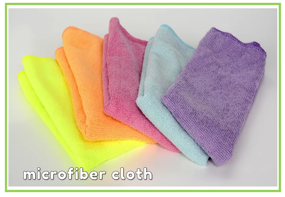 Labeled cleaning vocabulary flashcard showing five colorful cleaning cloths with the words 'microfiber cloth'
