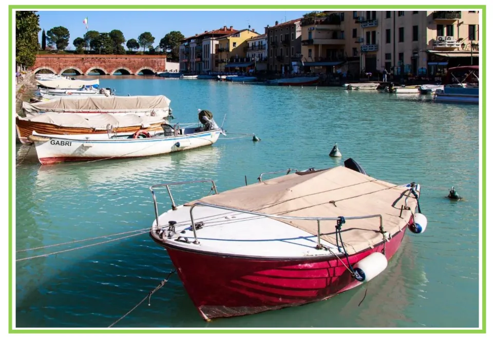 Picture-only watercraft vocabulary flashcard showing a red boat moored in a harbor, paired with the boat card