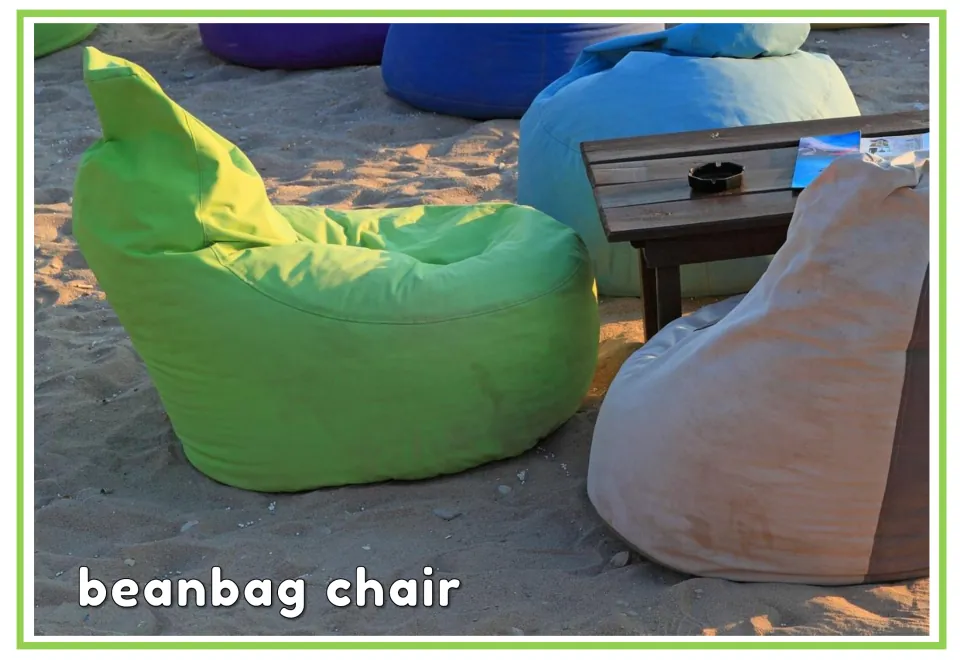 Labeled garden vocabulary flashcard showing beanbag chairs on sand with the vocabulary words 'beanbag chair'
