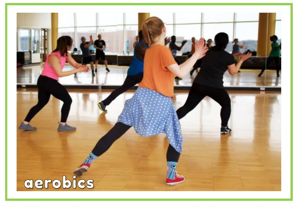 Gym vocabulary flashcard labeled 'aerobics' showing a group exercising together in a mirrored studio