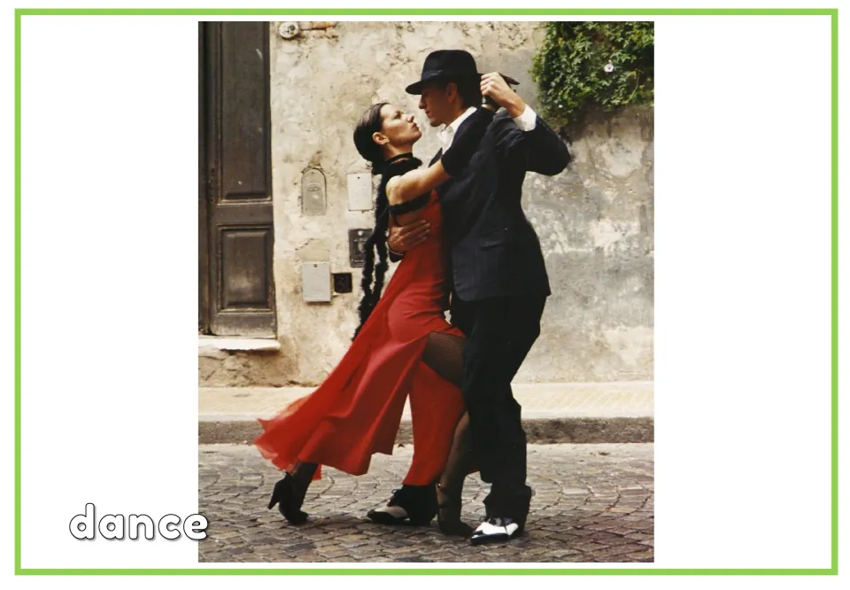 Labeled hobbies vocabulary flashcard showing two people dancing with the word 'dance' beneath the scene