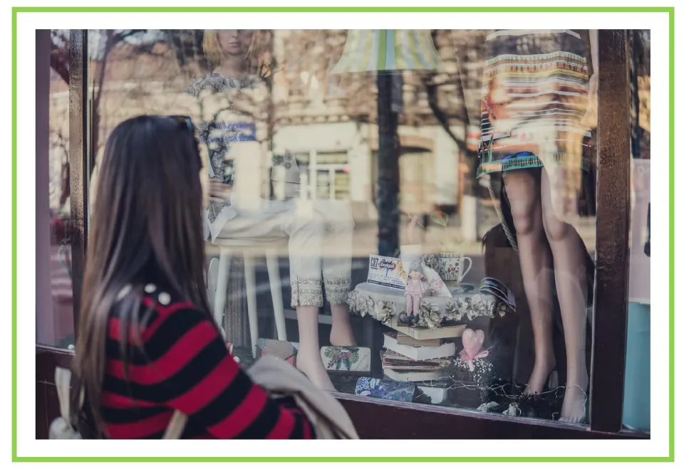 Picture-only shopping vocabulary flashcard showing a shopper looking at clothing in a shop window