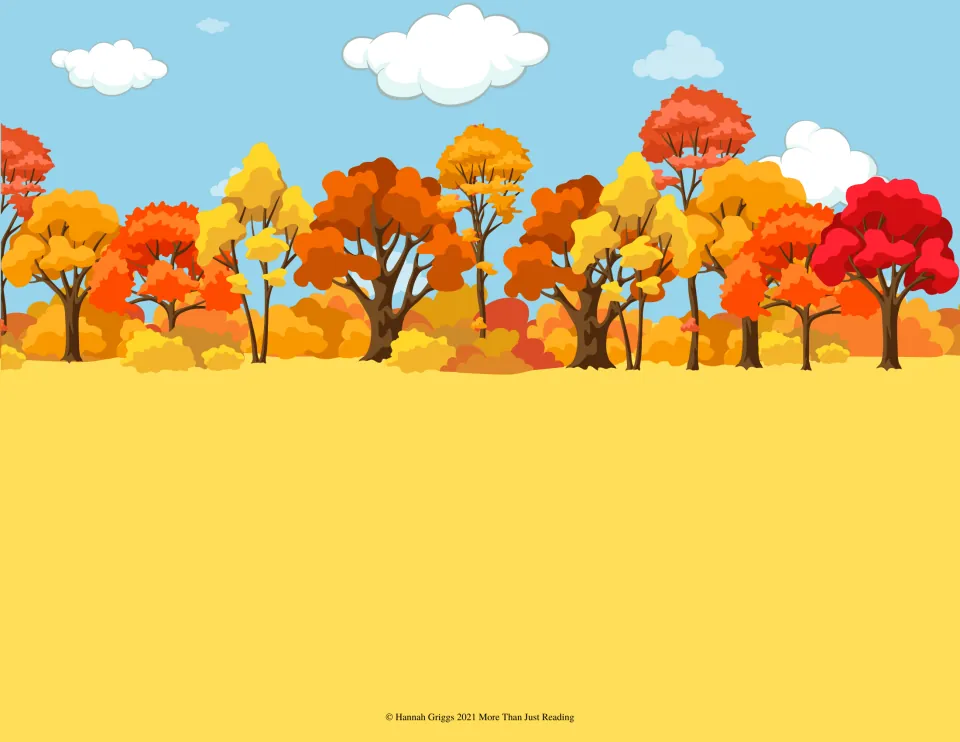 Autumn forest background: a row of red, orange and yellow trees under blue sky above an open field for placing stickers
