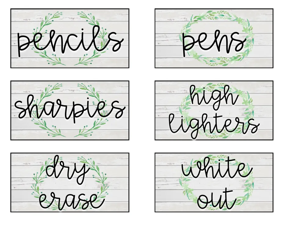 Supply labels with greenery on whitewashed wood: pencils, pens, sharpies, highlighters, dry erase and white out