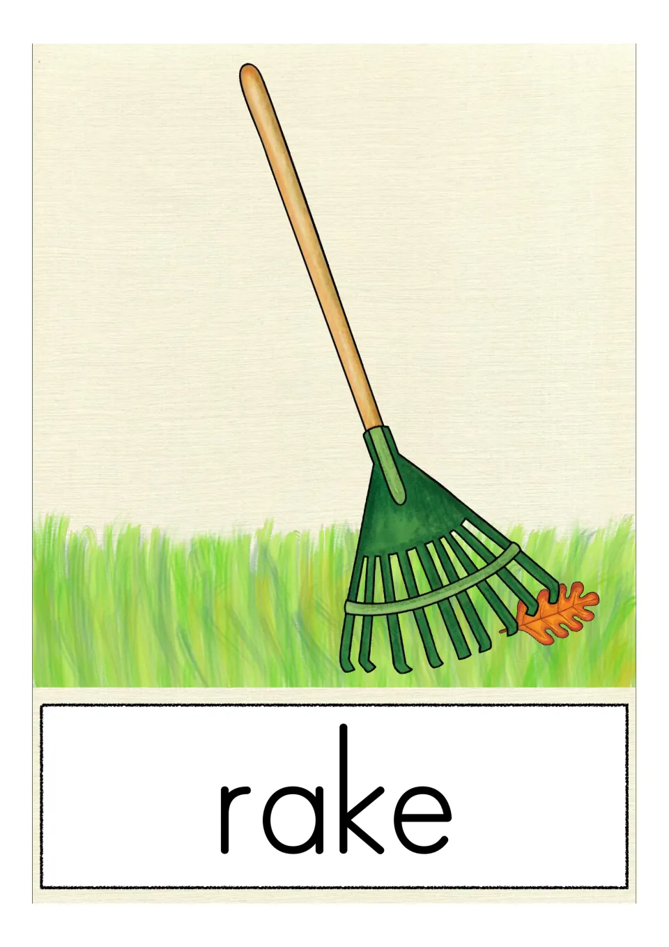 Vocabulary card for rake: a green garden tool with a wooden handle leans in the grass, an oak leaf caught in its tines