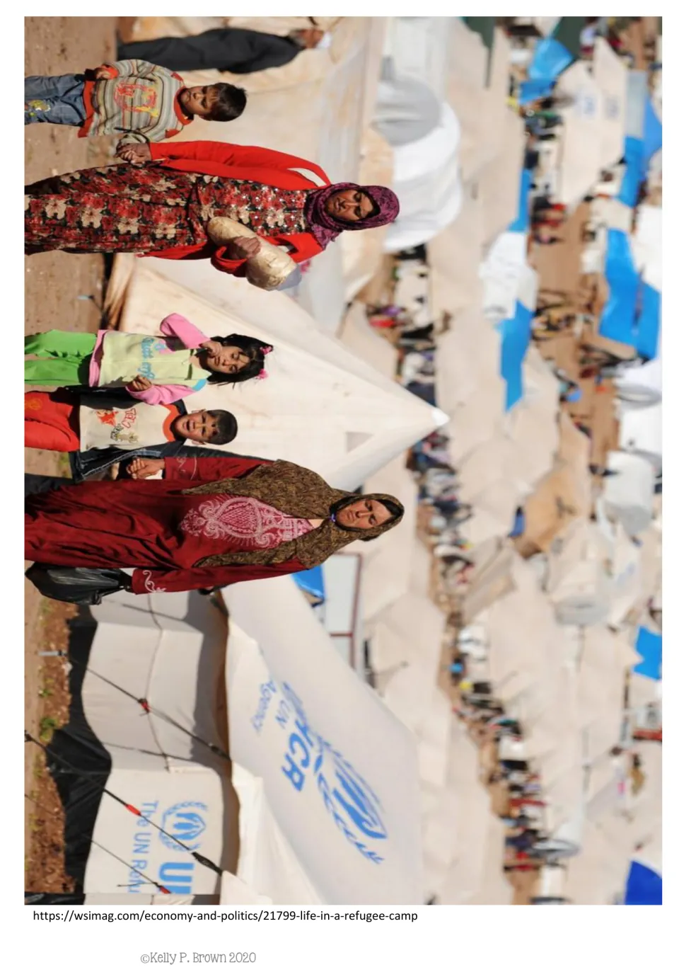 Reference photo for the picture-story vocabulary activity shows adults and children among refugee camp tents