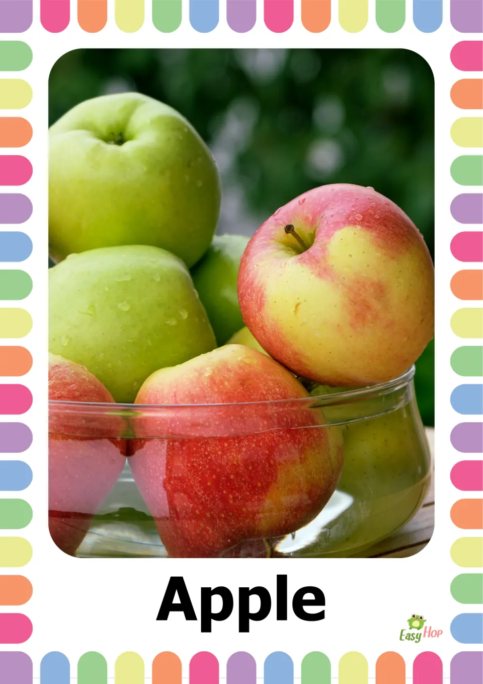 Apple flashcard: a real photo of green and red apples in a glass bowl above the word Apple, for naming fruit vocabulary