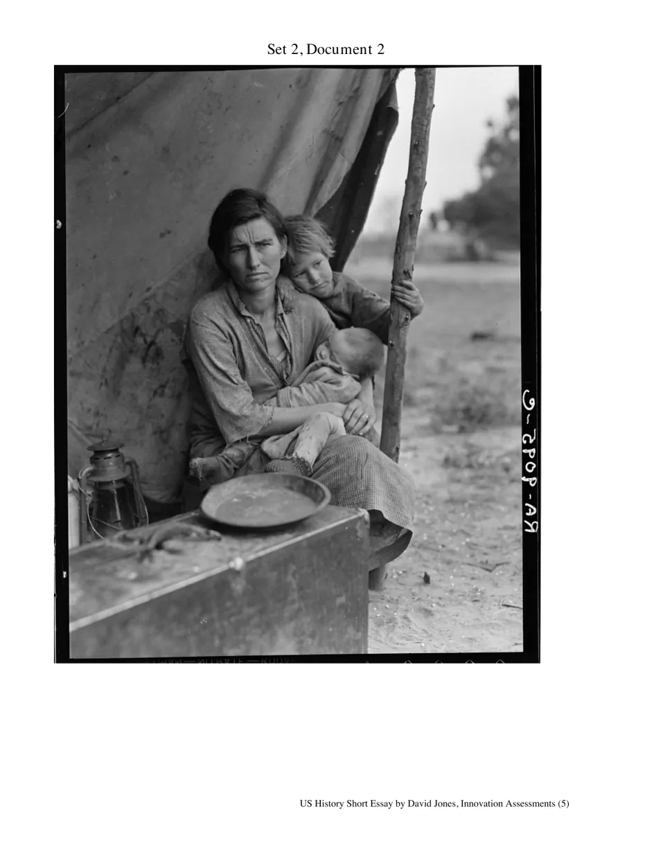 Depression-era photo of a mother holding a baby as a child leans on her at a tent camp, Set 2 Document 2
