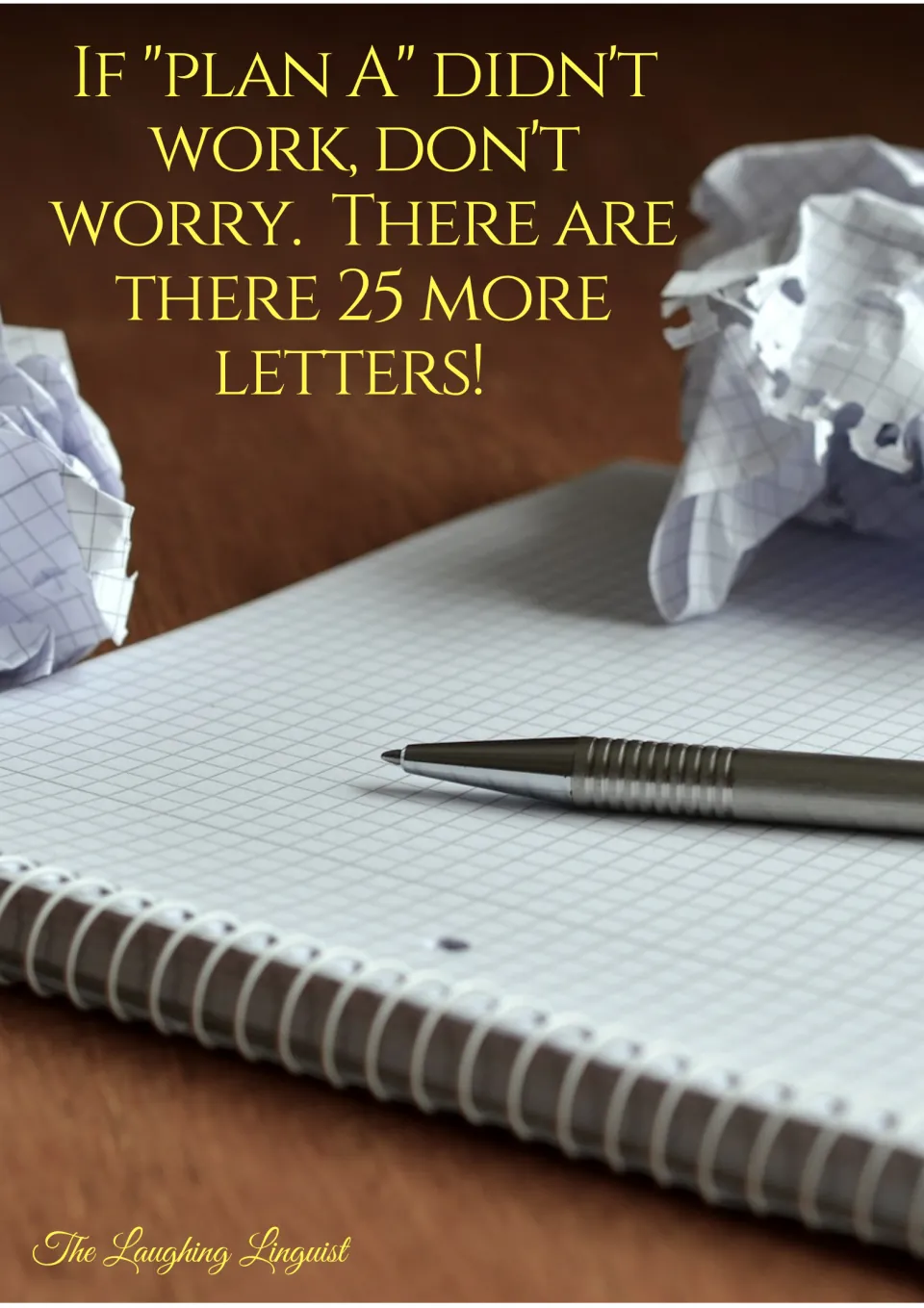 Trying-again poster: "If plan A didn't work, don't worry. There are 25 more letters!" over crumpled paper and a pen