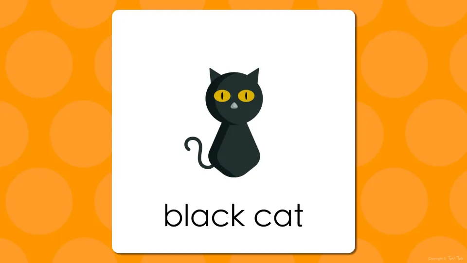 Halloween vocabulary slide showing the yellow-eyed black cat picture labeled black cat for students to read aloud