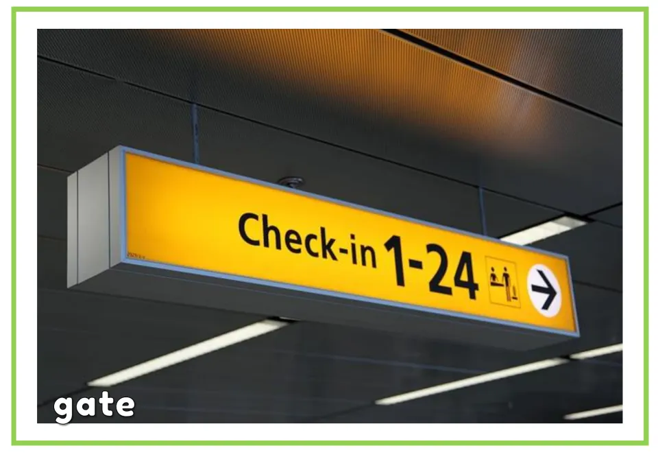Airport vocabulary flashcard labeled “gate,” showing a yellow check-in sign numbered 1–24 with an arrow