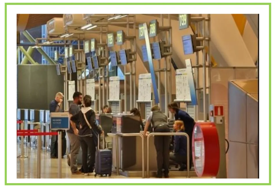 Airport vocabulary flashcard without a label, showing travelers and suitcases at staffed check-in counters