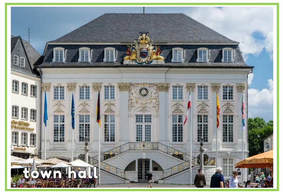 English vocabulary flashcard labeled "town hall," showing a civic building with a clock and staircases