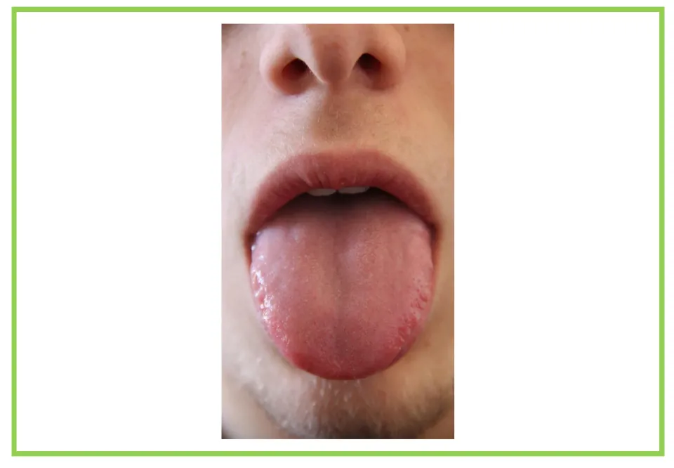 Picture-only body vocabulary flashcard showing a tongue extended from a mouth, paired with the tongue label