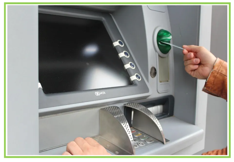 Picture-only banking vocabulary flashcard showing a person inserting a card into an ATM to access an account