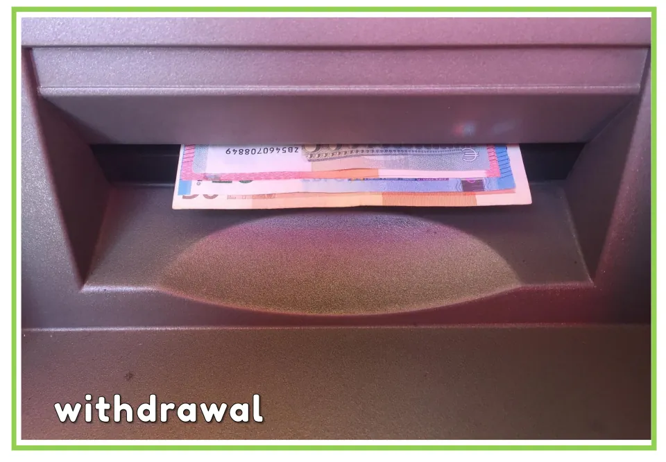 Labeled banking vocabulary flashcard showing euro banknotes in an ATM dispenser, with the word "withdrawal"