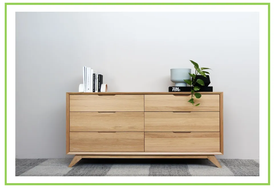 Picture-only furniture vocabulary flashcard showing a wooden chest of six drawers with books and plants on top
