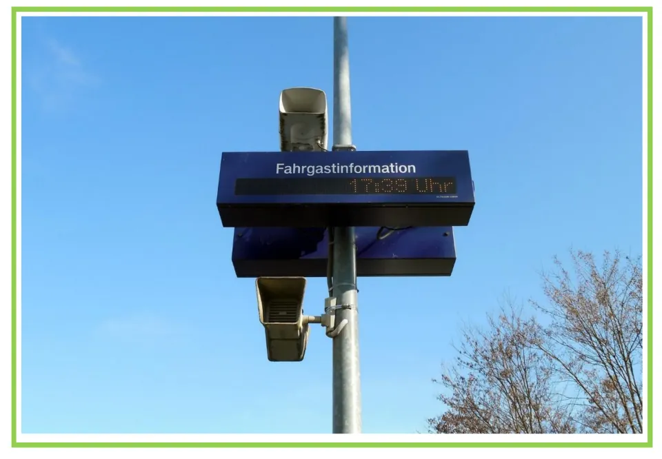 Picture-only announcement vocabulary flashcard showing train station loudspeakers and an information display