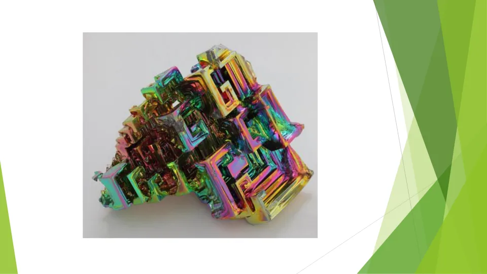 Crystalline solid photo: an iridescent rainbow-colored metal crystal built from stepped, square hollow formations