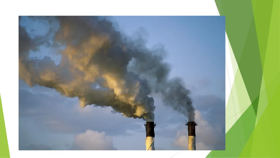Smoke and gases photo: dark plumes pouring from two industrial smokestacks and spreading across a blue sky