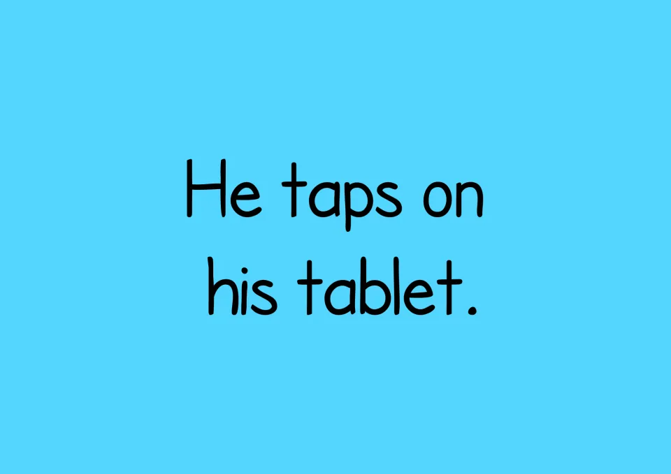 Story page reading "He taps on his tablet." in large print, a simple sentence for students to read and copy