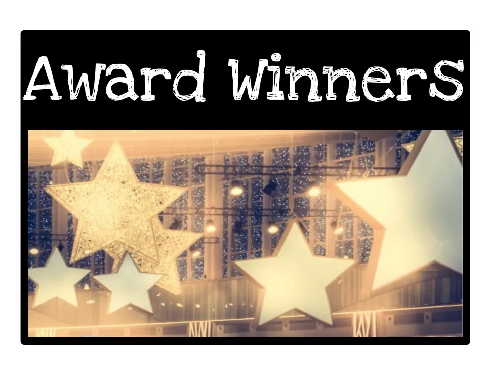 Award Winners bin label: photo of large glowing star decorations hanging in a lit hall below the topic title
