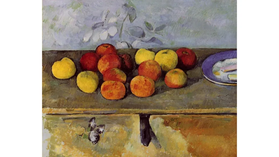 Art review slide showing a fruit still life on a wooden cabinet, with a plate at the right and floral wallpaper