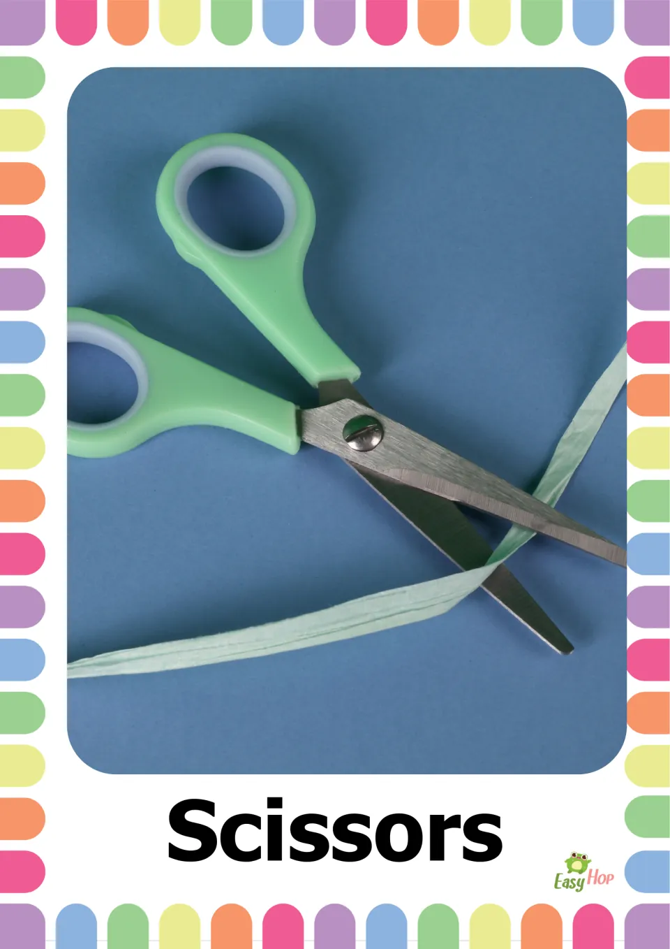 School supplies vocabulary flashcard labeled 'Scissors,' showing green-handled scissors cutting a thin strip