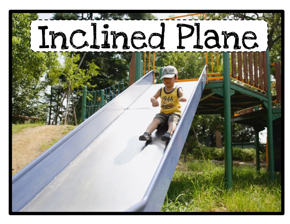 Inclined plane example: a child riding down a long metal playground slide shows a sloped surface in everyday use