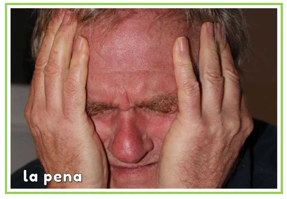 Spanish emotions flashcard labeled “la pena” (sorrow), showing a man holding his face with his eyes closed