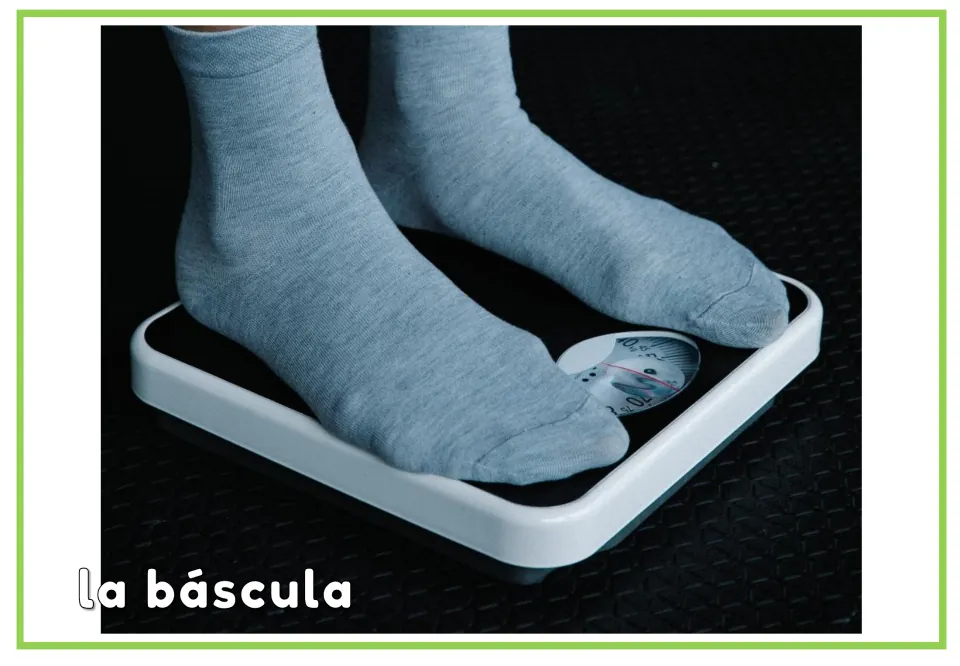 Spanish pharmacy vocabulary flashcard labeled 'la báscula' (scale), showing socked feet on a bathroom scale