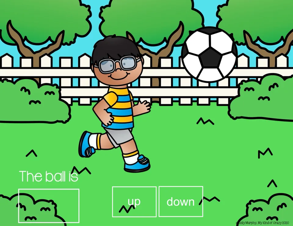 Spatial concepts slide: 'The ball is' with up/down choices and a soccer ball high in the air beside a boy.