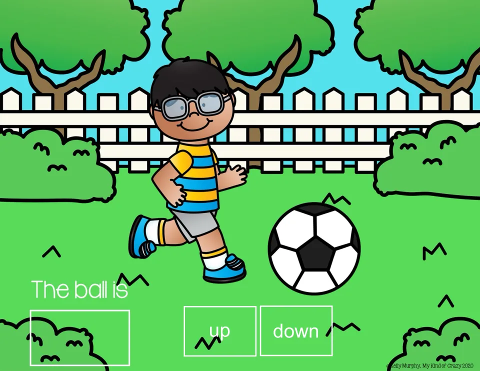 Spatial concepts slide: 'The ball is' with up/down choices and a soccer ball down near a boy's feet.